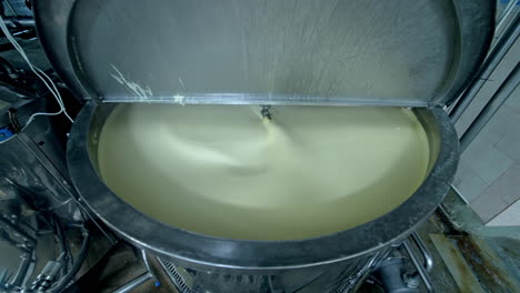 industrial equipment for making butter. modern container mixing butter at milk factory. creamy dairy product in a tank.
