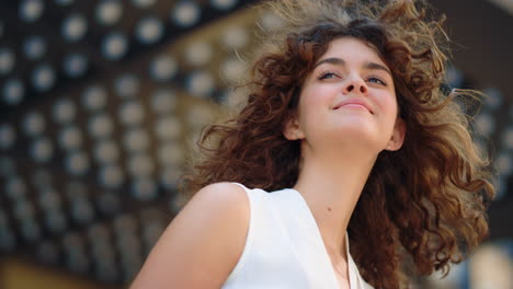Curly-girl-looking-into-distance-outdoors.-Fashion-model-smiling-outside.