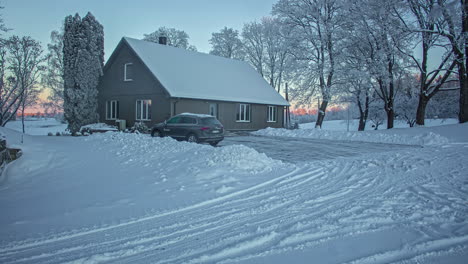 winter sunrise over a countryside cottage - dawn time lapse