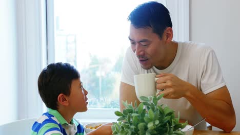 father and son having breakfast