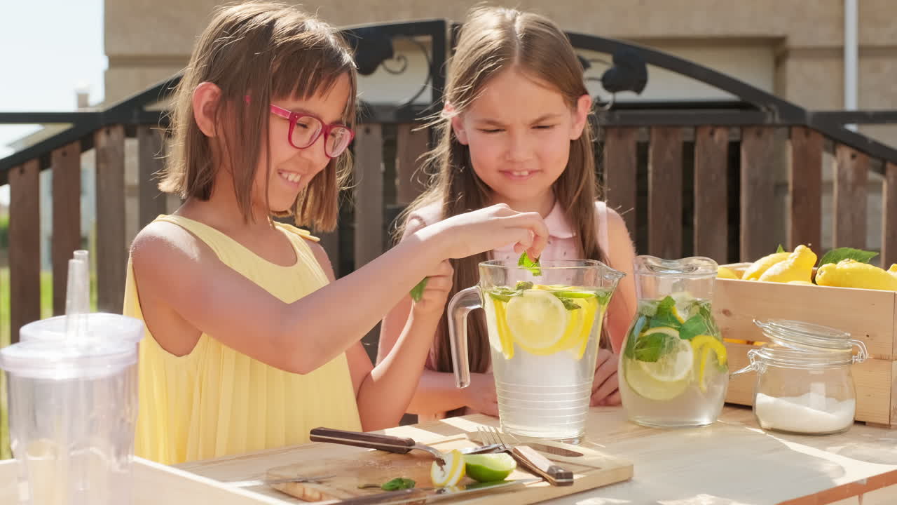Cute Girls Making Lemonade In Summer