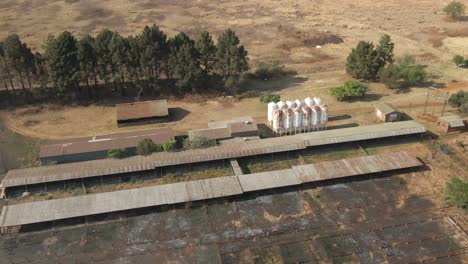 drone aerial footage of grain silo's at cattle feeding pens burnt out