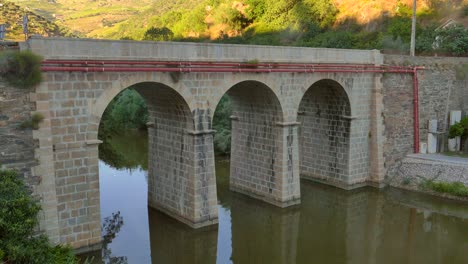 stone arch design of the old pinhao bridge at douro valley in portugal