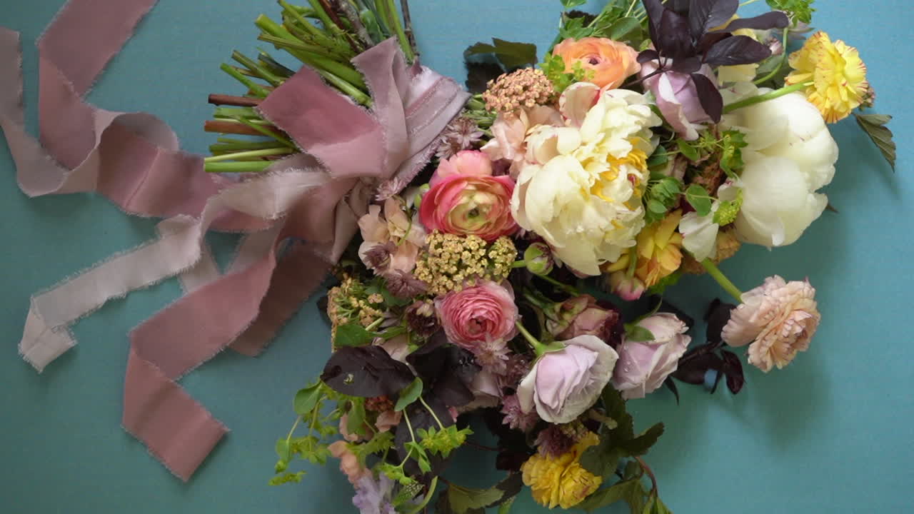 Bridal bouquet of a colorful flower arrangement for a stylish wedding - isolated flat lay