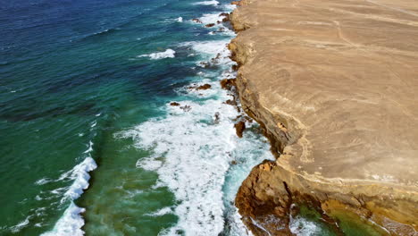 ajuy coastline with the calm ocean waves gently rolling on the shore