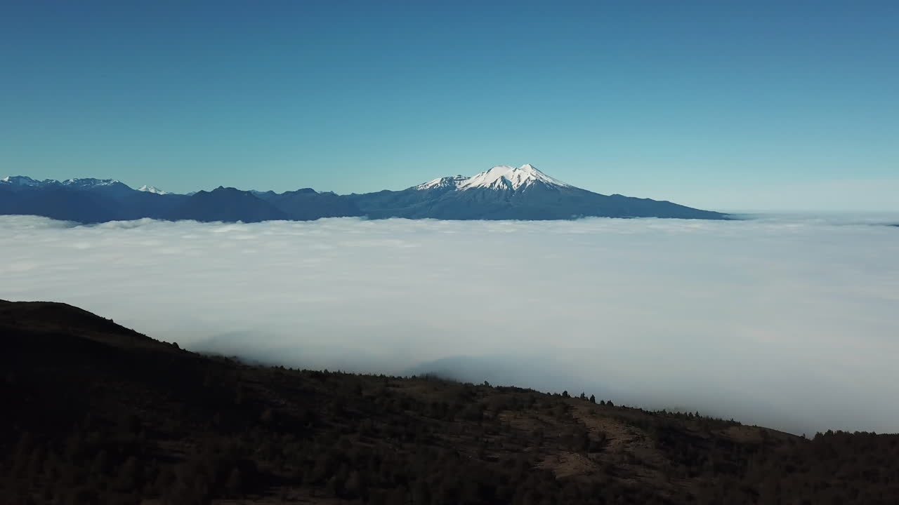 Aerial View of Thick Clouds in Volcanic Valley. Landscape of Highands of Chile