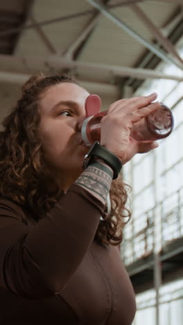 woman hydrating during a workout