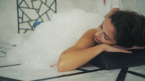 the young girl is given a bubble bath in the turkish bath