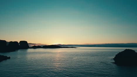 Incredible-drone-aerial-of-coral-sea-arch-and-coastal-lands-during-sunset