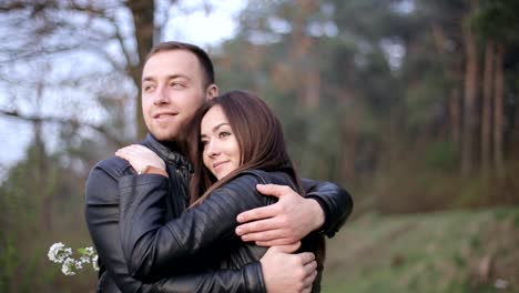 young couple embracing and enjoying time together in a park
