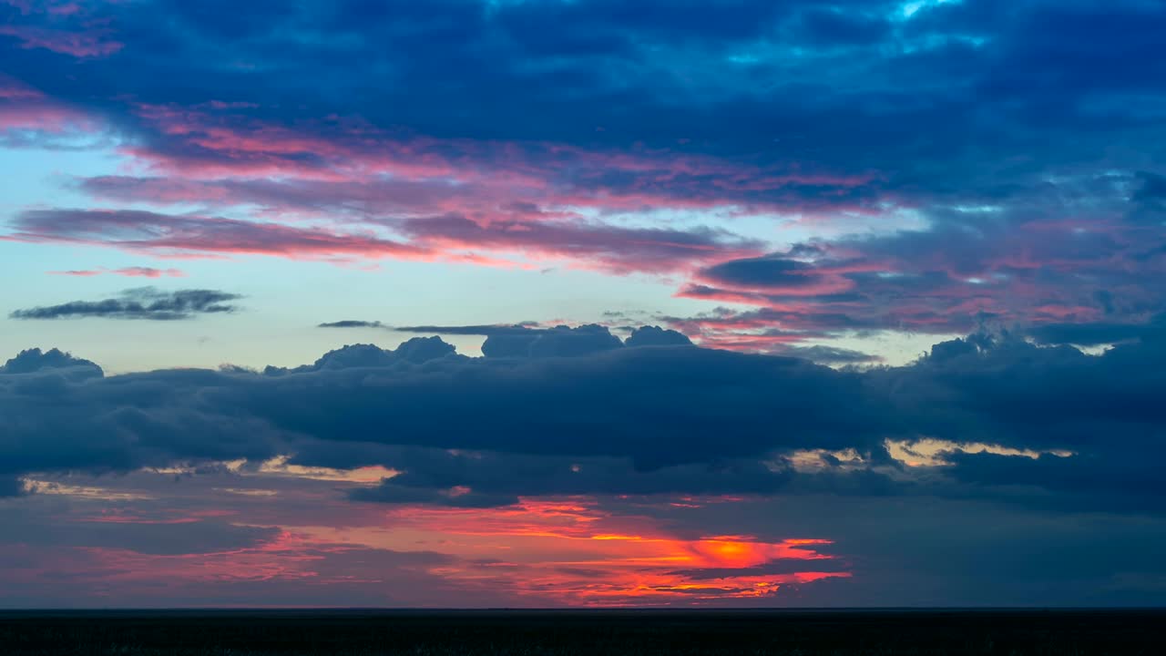 Time lapse of amazing red sunset with flowing clouds.