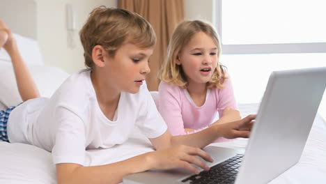 happy children using a laptop