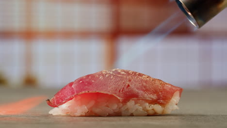 preparing a piece of spicy tuna sushi