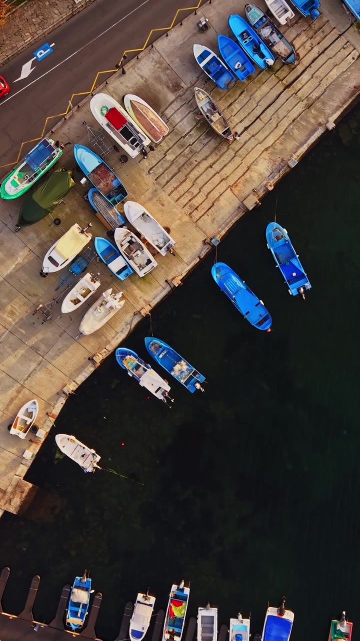 Fishing boats gather at the pier in Nesebar, Bulgaria during sunny weather
