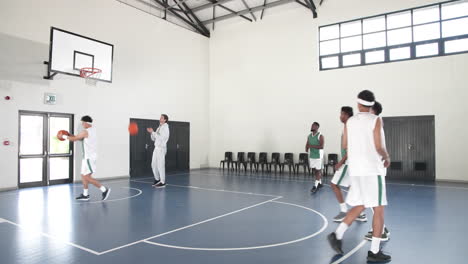 basketball players practicing shooting skills in school gym with coach observing