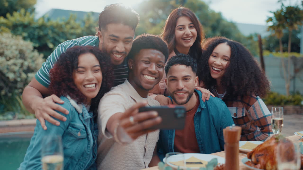 A joyful group of friends taking a selfie together outdoors