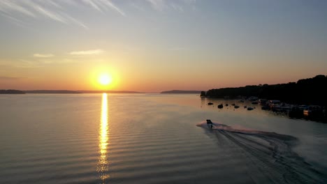 water skiing on lake geneva, wisconsin during golden hour from a aerial view