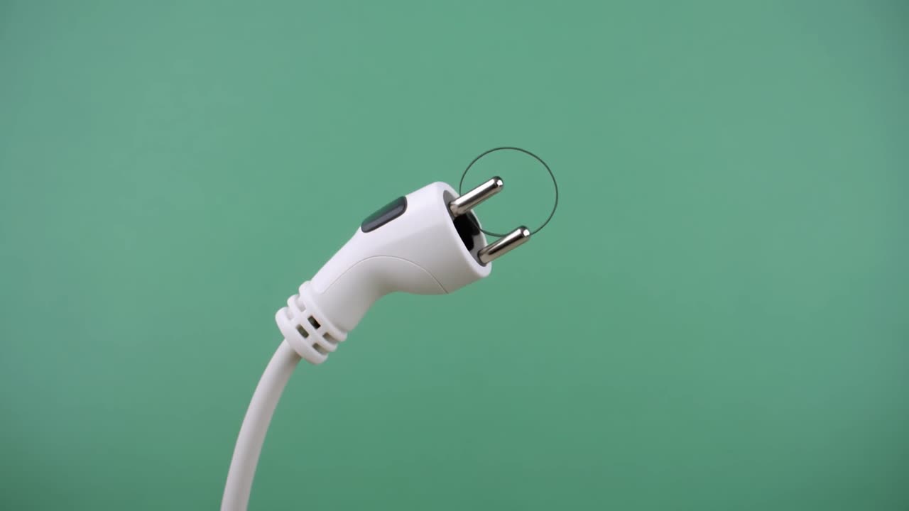 Close-up of Electrical Plug with Wire Connecting Prongs