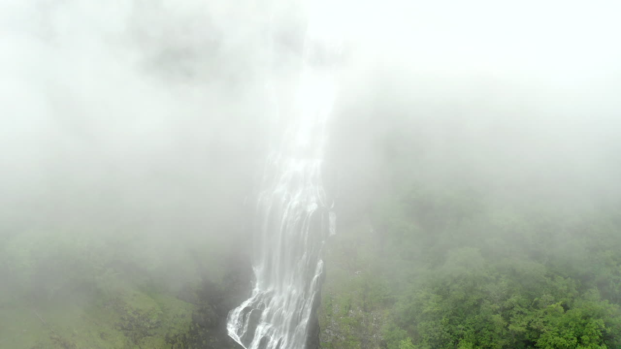 Aerial View of Waterfall in Foggy Forest