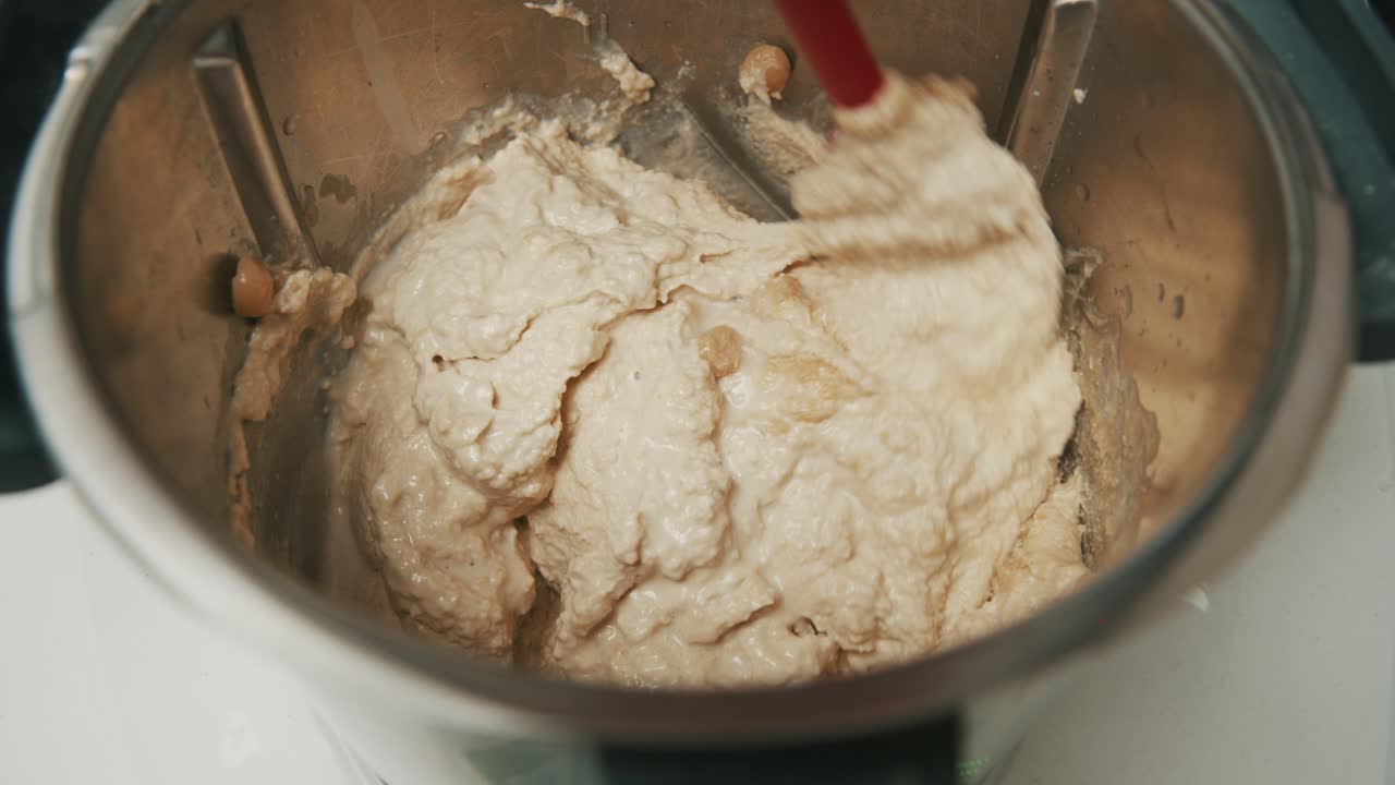 Homemade hummus paste in blender with whole chickpeas, preparation process