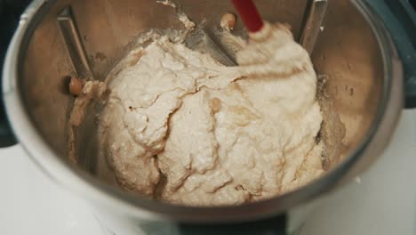 homemade hummus paste in blender with whole chickpeas, preparation process