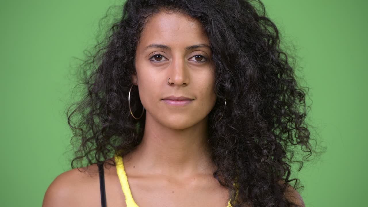 Young beautiful Hispanic woman with curly hair