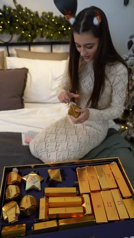 girl opening christmas advent calendar