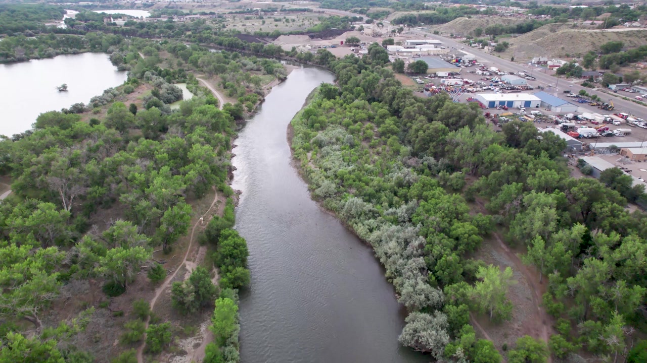 Aerial flight over the Arkansas river in Pueblo, Colorado. Part of the city of Pueblo can be seen on the right.
