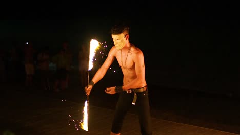 performer showcasing fire skills on the beach