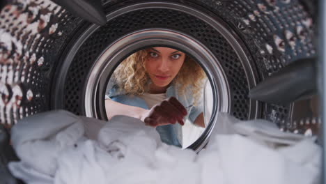 View-Looking-Out-From-Inside-Washing-Machine-As-Woman-Takes-Out-Laundry