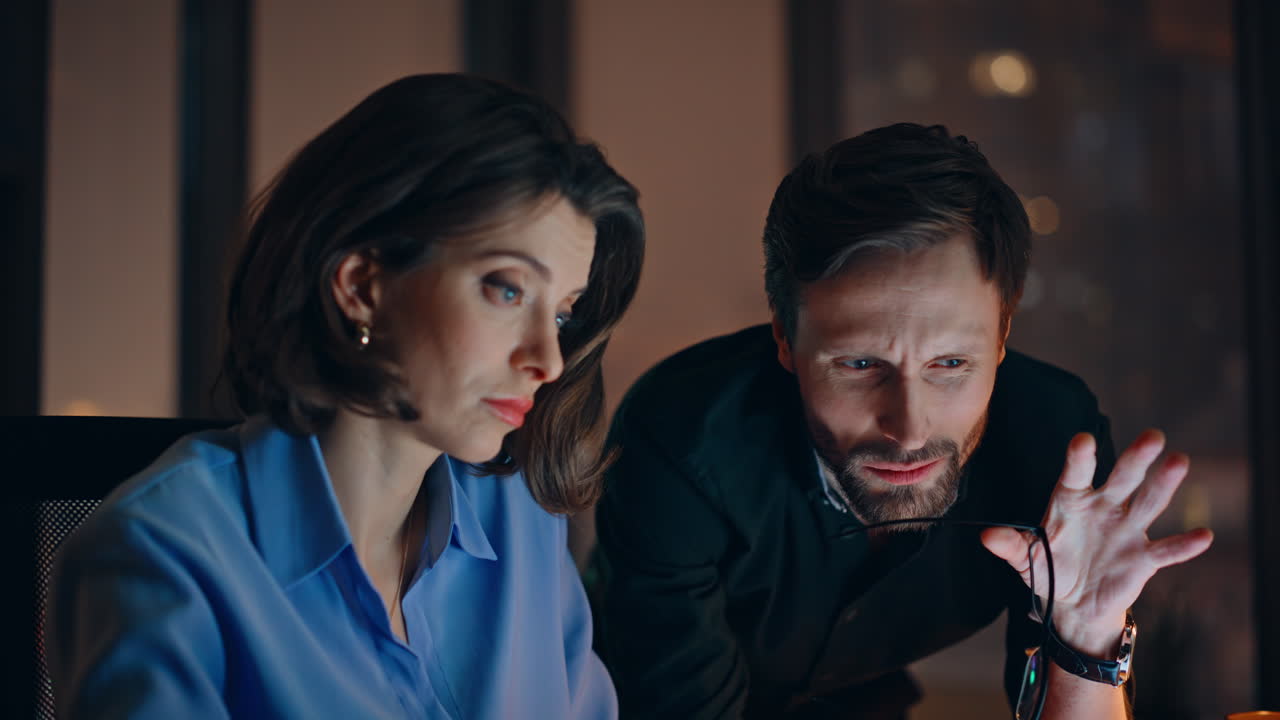 Overtime staff collaborating project discussing problems at dark office closeup