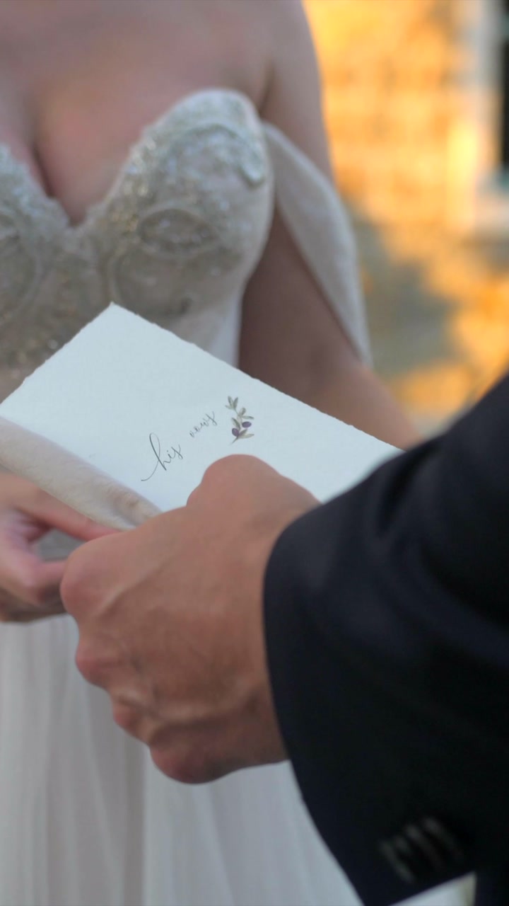 groom reading vows to bride, closeup slow motion, elegant wedding dress classy elopement, vertical shot
