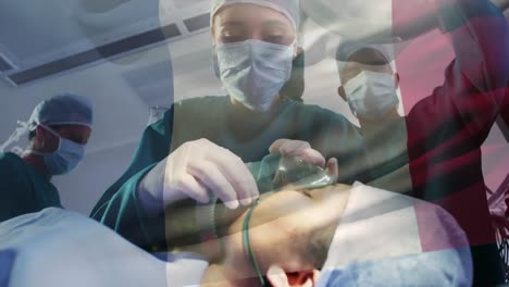 Animation-of-flag-of-france-waving-over-surgeons-in-operating-theatre