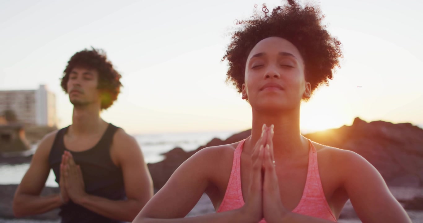 Couple Meditating on Beach with Digital Social Media Notifications