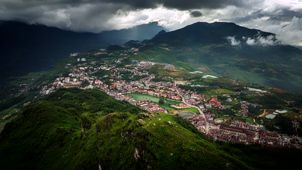 Drone hyperlapse view from iconic Dragon Jaw mountain over mountainous town Sapa