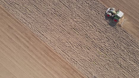 Dynamic-aerial-of-tractor-plowing-an-empty-field