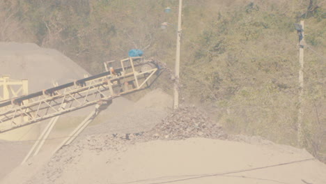 dusty asphalt quarry, rocks, gravel, cinematic tilt up wide shot, paraguay