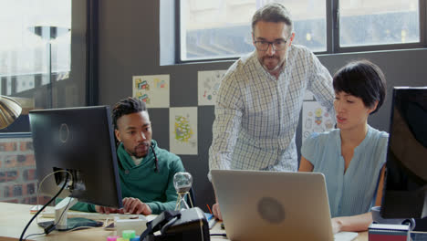 business people discussing over laptop in office 4k