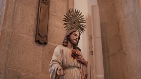 statue of jesus with sacred heart in quiet church interior soft natural light