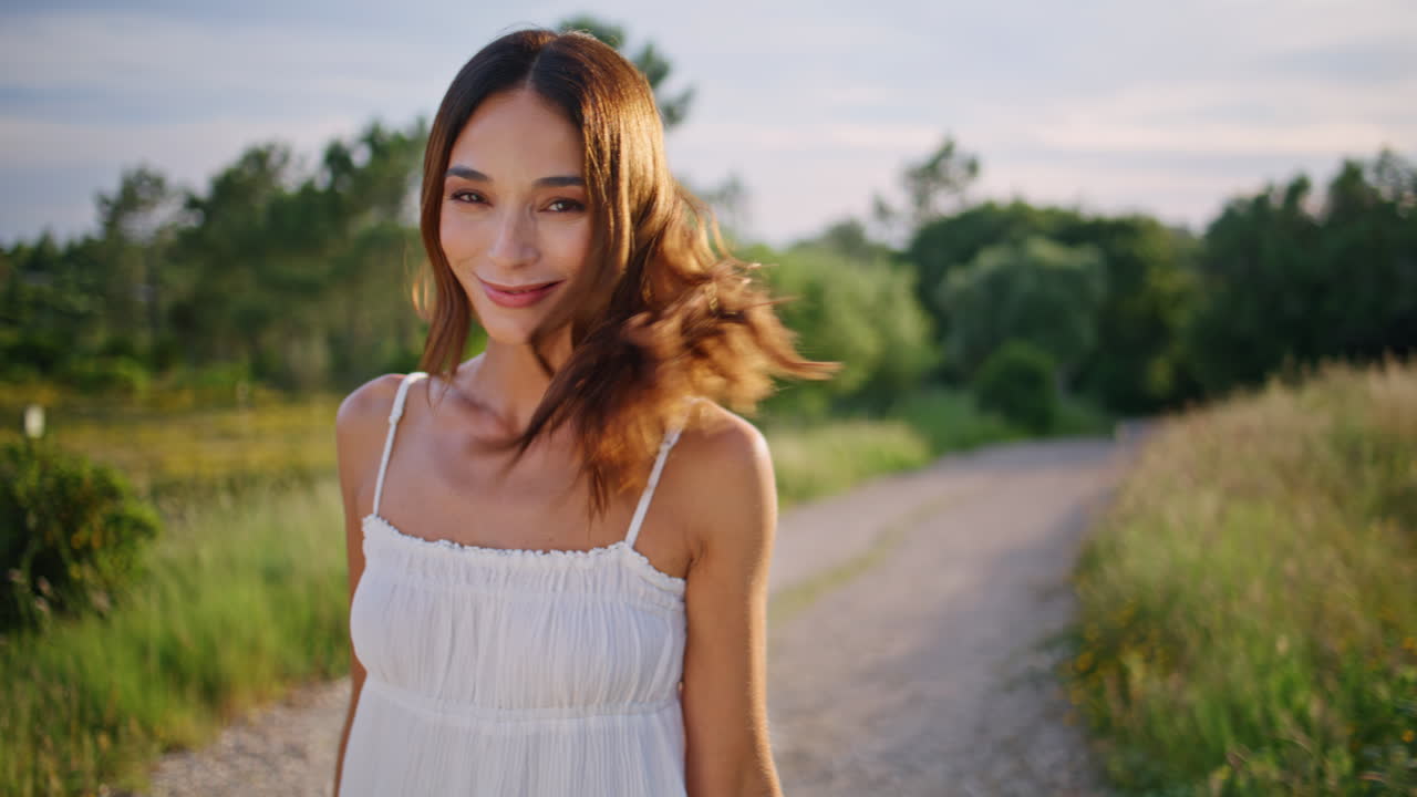 Joyful brunette jumping country path closeup. Happy smiling woman turning camera