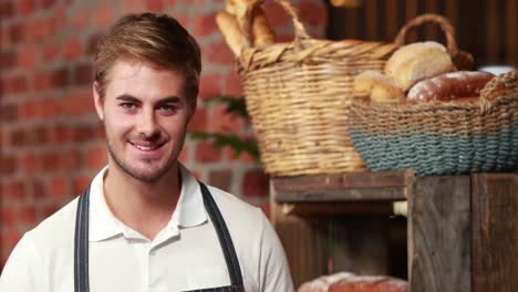 smiling waiter holding a cup of coffee