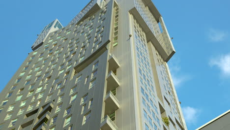 high-rise building with geometric design against blue sky