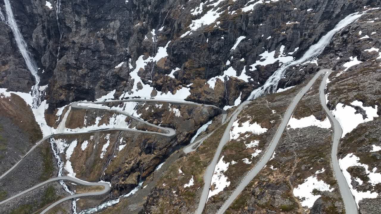 Rising aerial over dramatic Trollstigen Road winding up Norway mountain pass