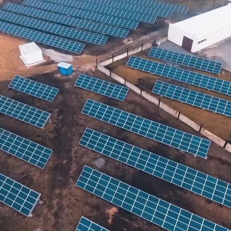 solar panels on the field. photovoltaic cells on the solar farm receive clean ecological energy from the sun. renewable energy. camera rising up. aerial view.