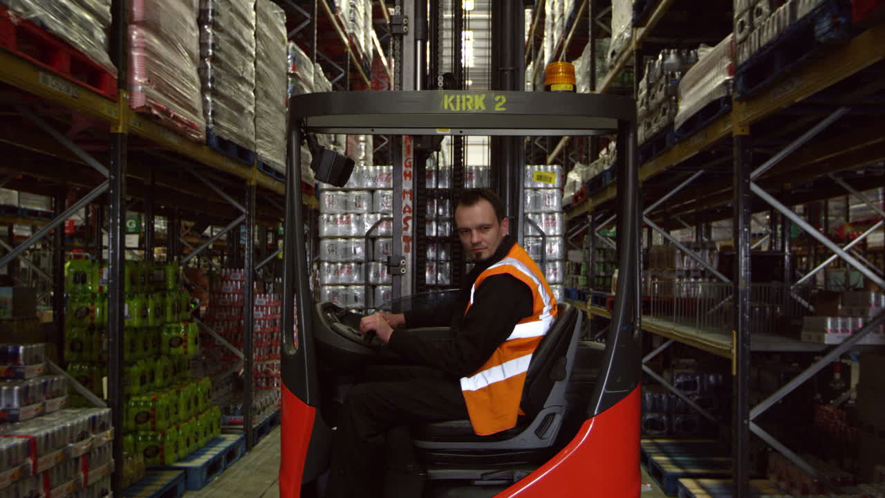 Forklift driver moving full pallet in warehouse, shot on R3D