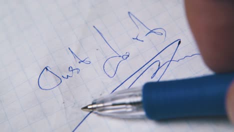 young-man-holds-pen-above-words-JUST-DO-IT-on-paper-sheet