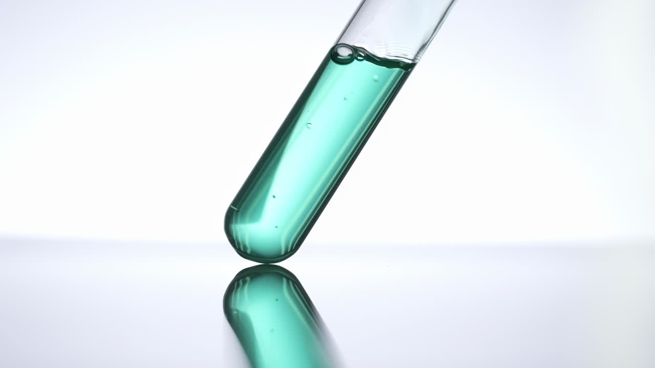 Lab researcher Pipette drop pink transparent liquid sample into test tube in laboratory for scientific analysis