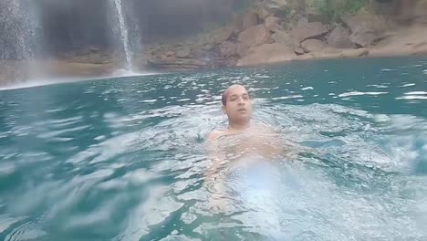 young-man-swimming-in-clear-blue-water-at-day