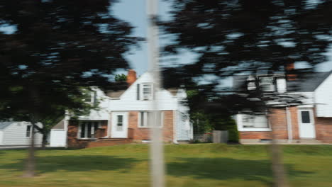 Traveling In The Suburbs Of The United States A View From A Car Window On Beautiful American Houses 