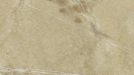 aerial drone footage begins with a top-down view, gradually rising to reveal hundreds of solar panels at a power plant in uliastai, mongolia, showcasing the vast landscape and renewable energy reach.